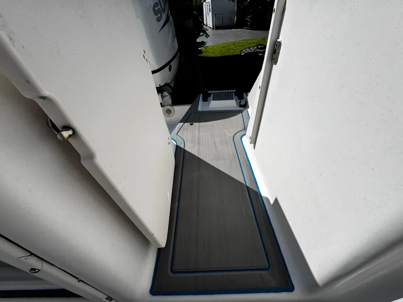 Slide: The Image of 2004 Robalo R 260 boat interior with gray flooring and open door. - 11