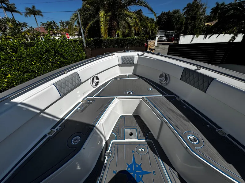 Slide: The Image of 2004 Robalo R 260 boat interior with cushioned seating and sleek design. - 20