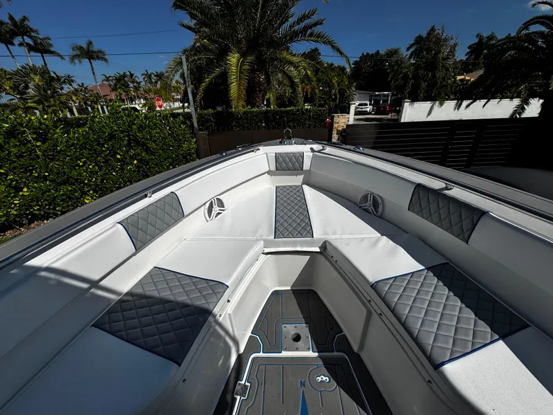 Slide: The Image of 2004 Robalo R 260 boat interior with cushioned seating and sleek design. - 21