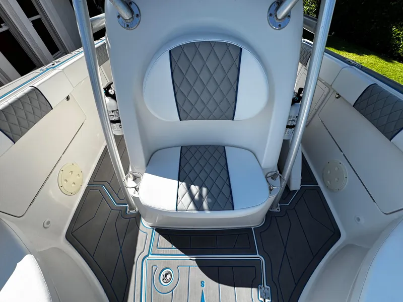 Slide: The Image of 2004 Robalo R 260 boat interior with gray and white seating and flooring. - 25