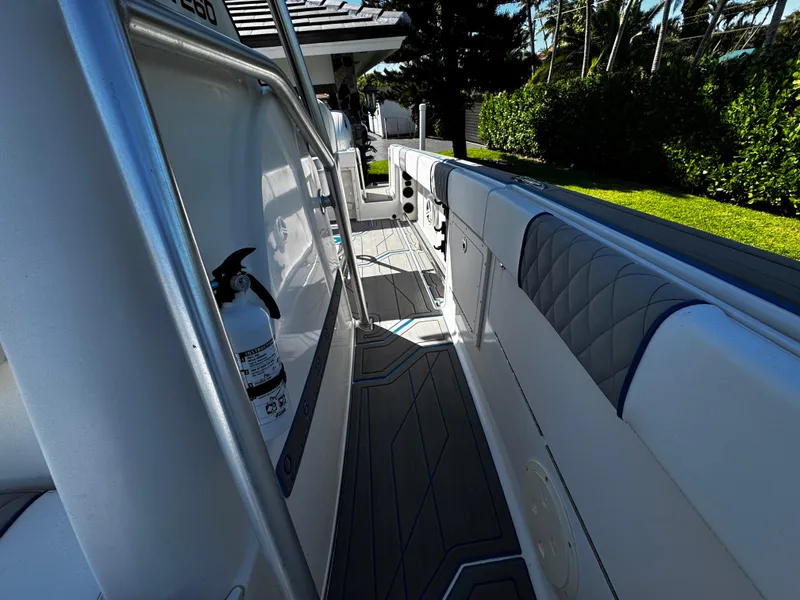 Slide: The Image of 2004 Robalo R 260 boat interior with cushioned seating and fire extinguisher. - 27