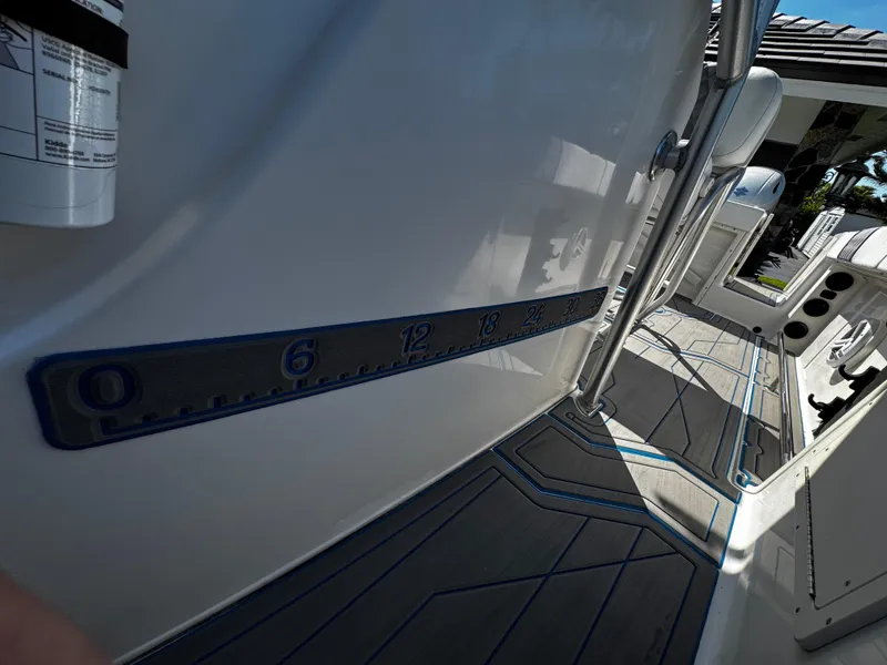 Slide: The Image of 2004 Robalo R 260 boat interior with measurement markings on deck. - 28