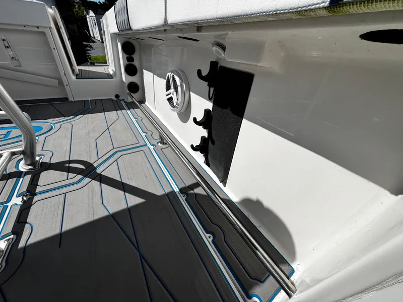 Slide: The Image of 2004 Robalo R 260 boat interior with custom flooring and rod holders. - 29