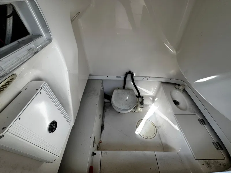 Slide: The Image of 2004 Robalo R 260 boat interior with storage and equipment compartments. - 31