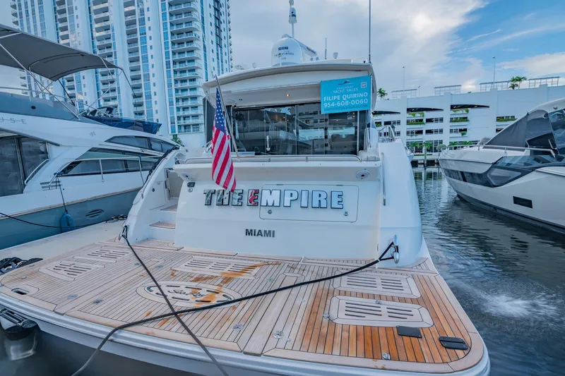 Slide: The Image of 2018 Sea Ray L590 yacht docked in Miami marina with American flag. - 12