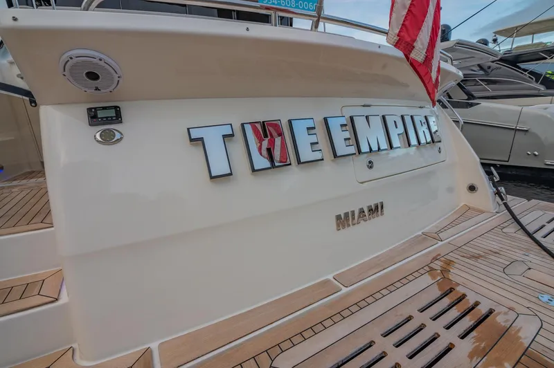 Slide: The Image of 2018 Sea Ray L590 yacht docked, displaying THE EMPIRE and MIAMI on the stern. - 13