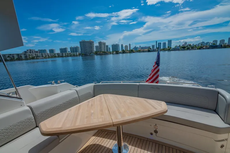 Slide: The Image of 2018 Sea Ray L590 yacht with a scenic waterfront view and American flag. - 17