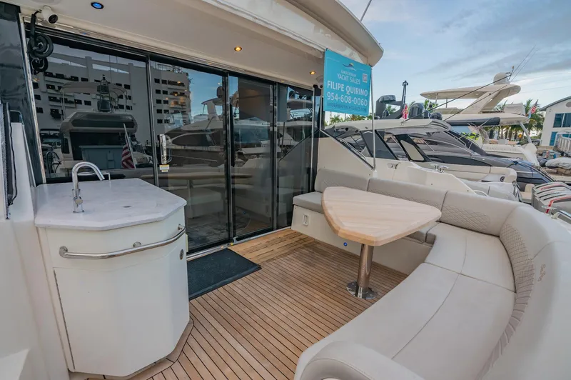 Slide: The Image of 2018 Sea Ray L590 yacht with outdoor seating and kitchenette. - 19
