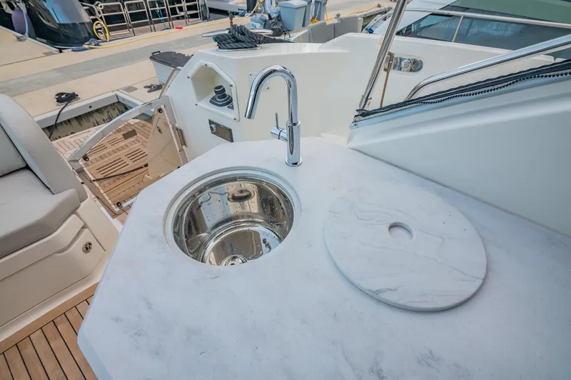 Slide: The Image of 2018 Sea Ray L590 yacht sink and countertop area. - 21
