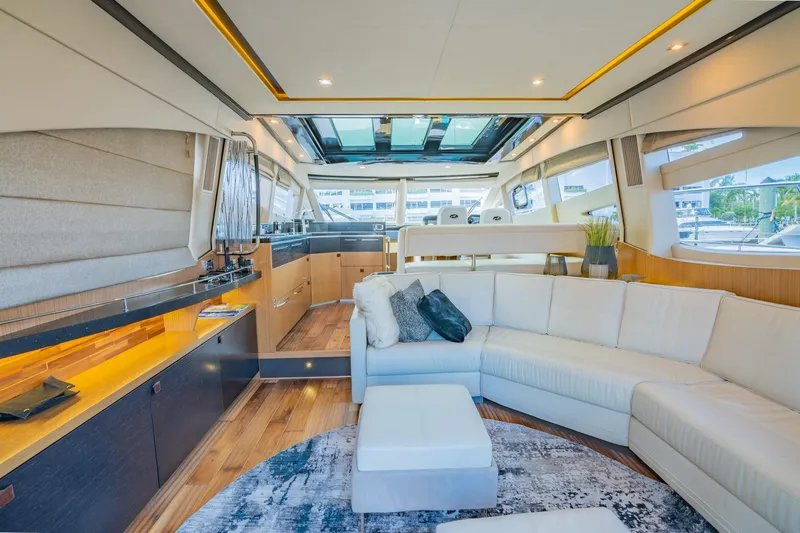 Slide: The Image of Luxurious interior of 2018 Sea Ray L590 yacht with white sectional sofa and modern decor. - 23