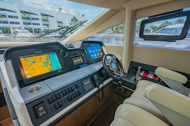 Slide: The Image of 2018 Sea Ray L590 yacht helm with advanced navigation systems and luxurious seating. - 30