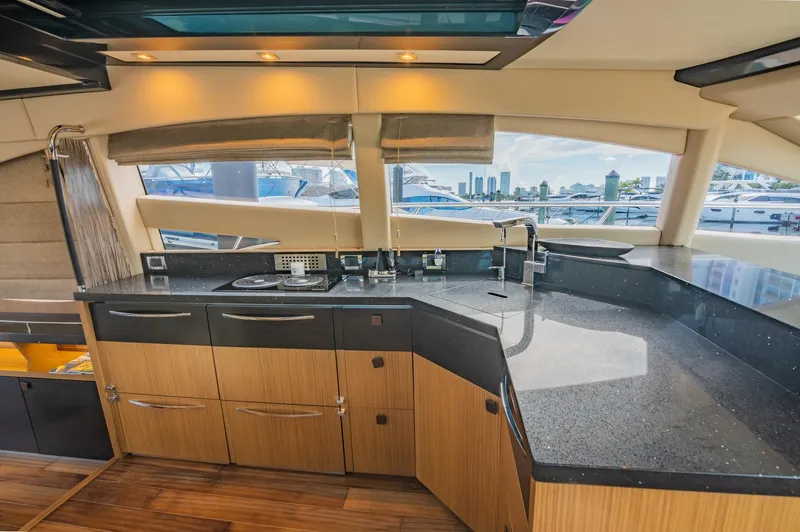 Slide: The Image of Modern kitchen interior of 2018 Sea Ray L590 yacht with sleek countertops and ample storage. - 34