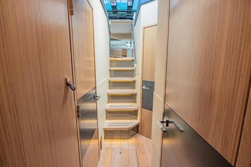 Slide: The Image of Interior hallway of 2018 Sea Ray L590 yacht with wooden finishes and stairs. - 37