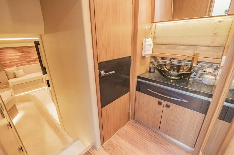 Slide: The Image of 2018 Sea Ray L590 yacht interior, featuring a modern bathroom and cozy living area. - 44