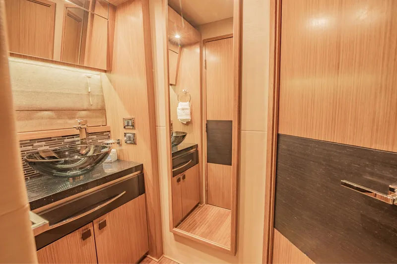 Slide: The Image of Luxurious bathroom interior of 2018 Sea Ray L590 yacht with modern fixtures and wooden cabinetry. - 45