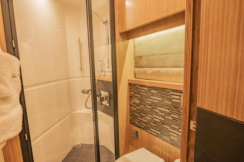 Slide: The Image of Luxurious bathroom in 2018 Sea Ray L590 yacht with modern fixtures and elegant design. - 46