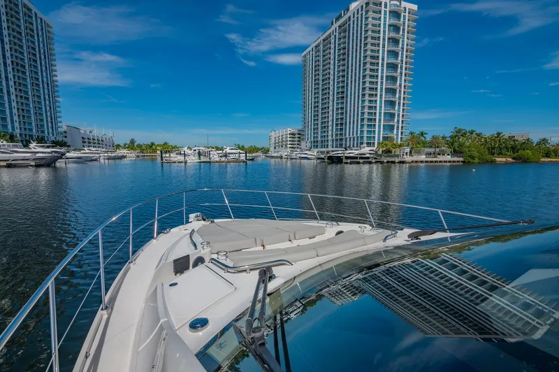 Slide: The Image of View from the bow of a 2018 Sea Ray L590 yacht in a marina with high-rise buildings. - 5
