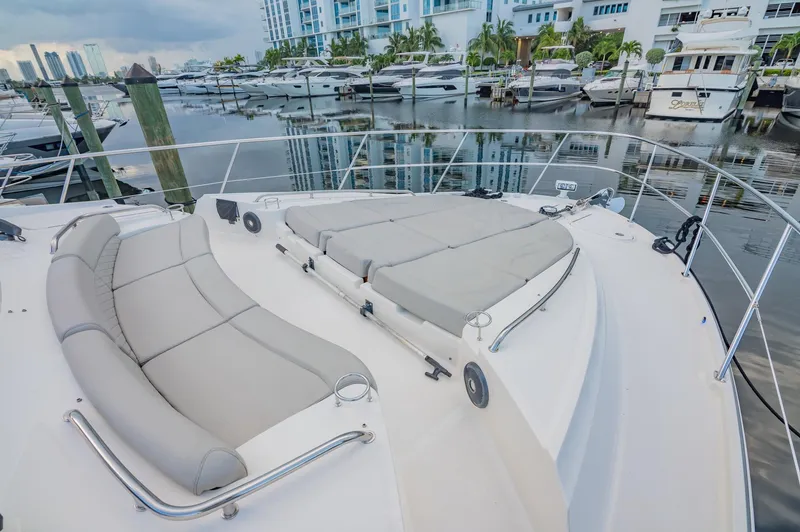 Slide: The Image of 2018 Sea Ray L590 yacht with spacious deck and luxurious seating at marina. - 7