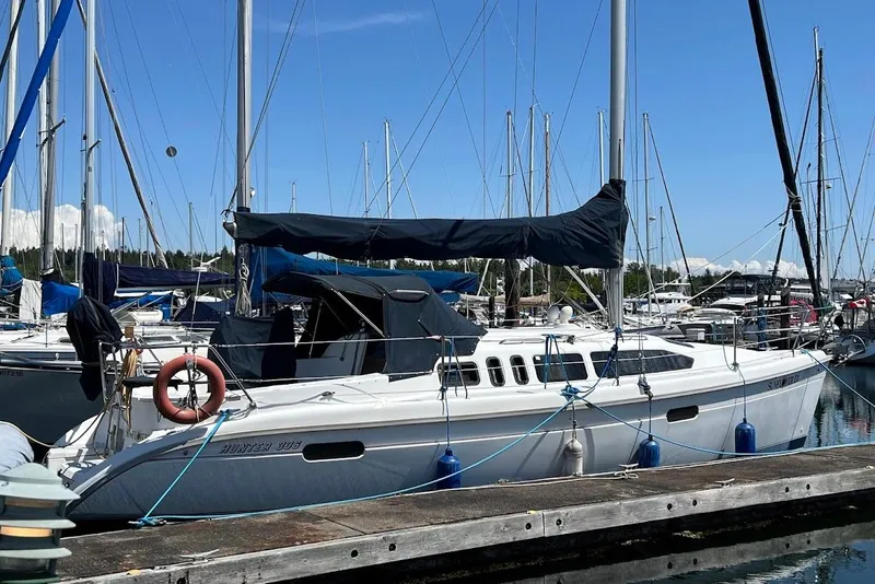 Slide: The Image of 1995 Hunter 336 sailboat docked in calm marina. - 1