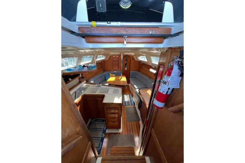 Slide: The Image of Interior of 1995 Hunter 336 sailboat with wood finish and cozy seating area. - 10