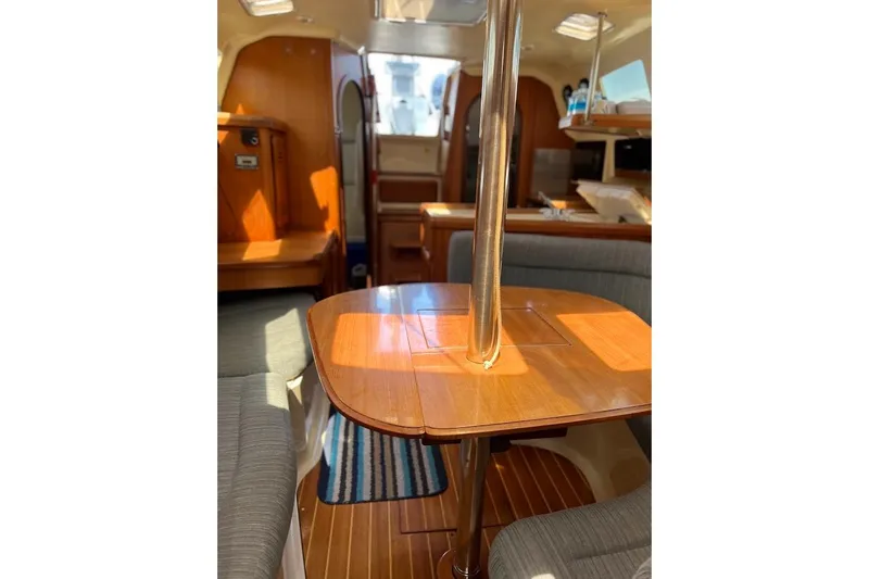 Slide: The Image of Interior of 1995 Hunter 336 sailboat with wooden table and seating area. - 13