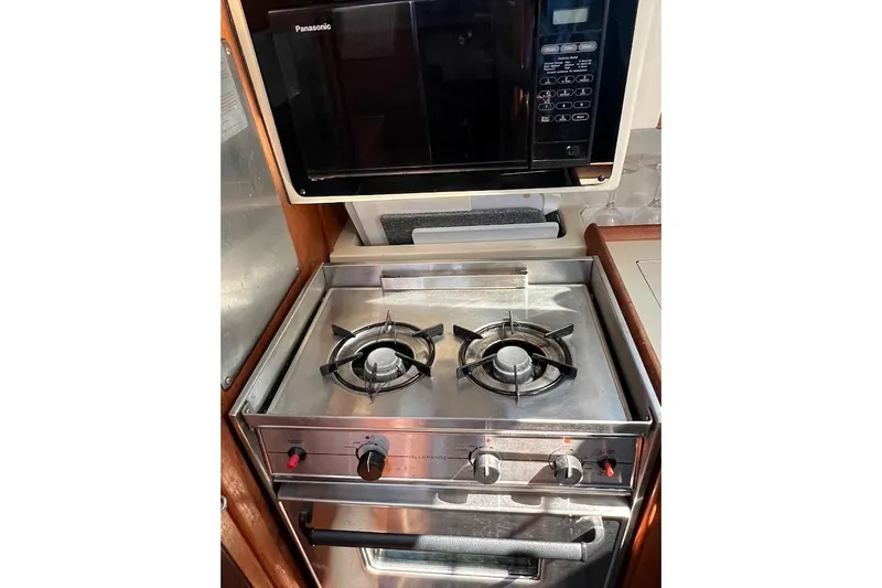 Slide: The Image of 1995 Hunter 336 yacht kitchen with stove and Panasonic microwave. - 16