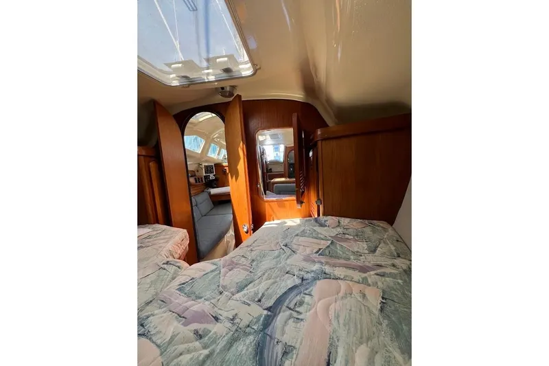 Slide: The Image of Interior of 1995 Hunter 336 sailboat with cozy cabin and patterned bedding. - 22