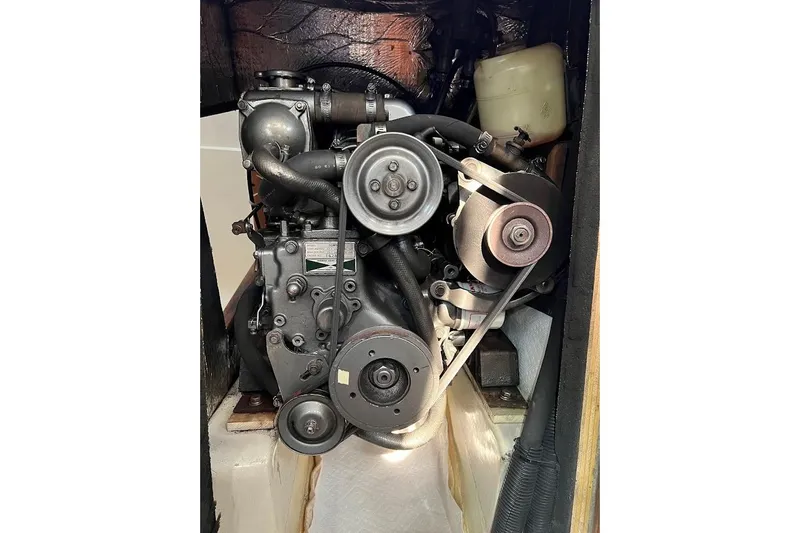 Slide: The Image of Engine of a 1995 Hunter 336 sailboat, showcasing belts and components. - 26