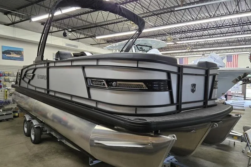 The Image of 2026 AquaPatio 235 DFL pontoon boat displayed indoors, showcasing sleek design and modern features. - 0