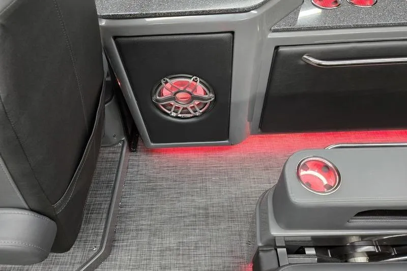 Slide: The Image of Interior of 2026 AquaPatio 235 DFL boat with speaker and red ambient lighting. - 15