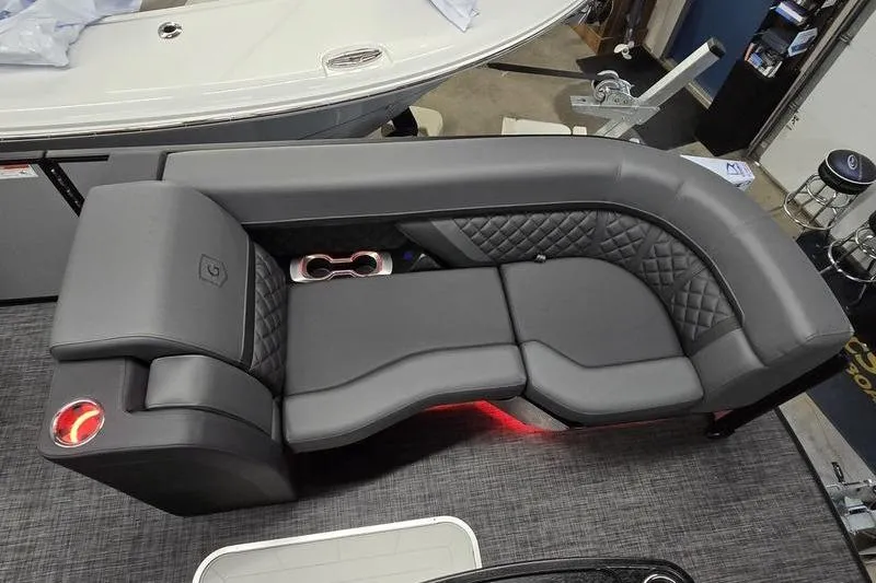 Slide: The Image of Luxurious seating on 2026 AquaPatio 235 DFL boat, featuring quilted upholstery and ambient lighting. - 16