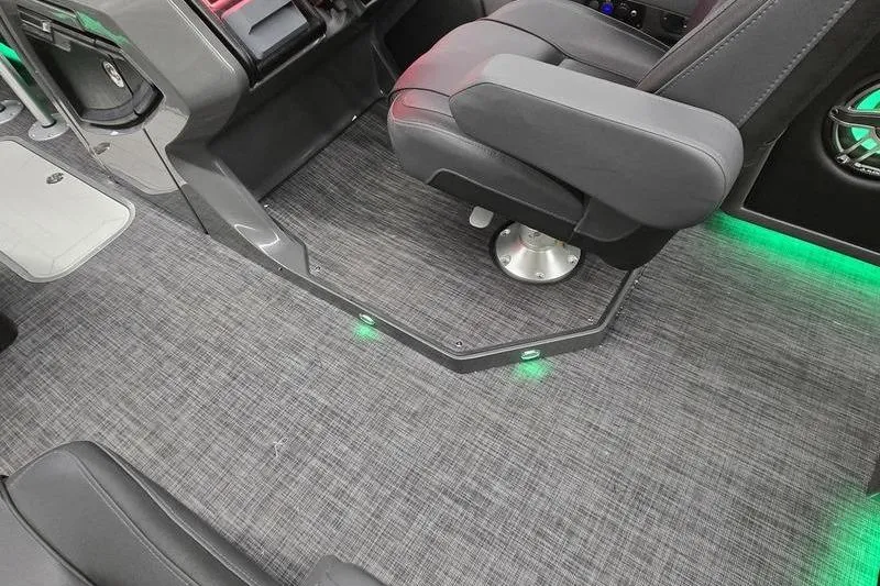 Slide: The Image of Interior of 2026 AquaPatio 235 DFL boat with gray seating and ambient lighting. - 18