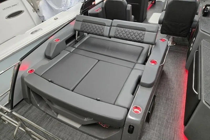 Slide: The Image of 2026 AquaPatio 235 DFL boat interior with luxurious seating and cup holders. - 8