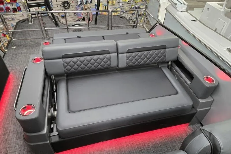 Slide: The Image of Luxurious seating on 2026 AquaPatio 235 DFL boat with red LED lighting and cup holders. - 9