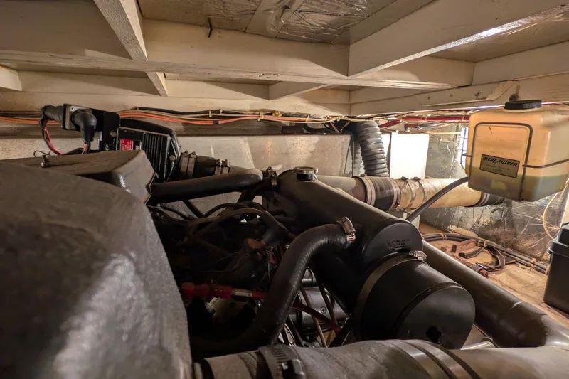 Slide: The Image of Engine room of a 1984 Chris-Craft 382 Commander boat, showcasing mechanical components. - 101
