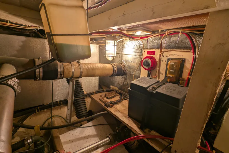 Slide: The Image of Engine room of 1984 Chris-Craft 382 Commander with wiring and battery components. - 105