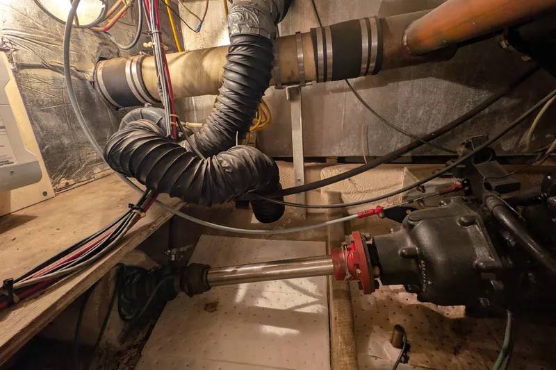 Slide: The Image of Engine room of 1984 Chris-Craft 382 Commander with visible pipes and wiring. - 109