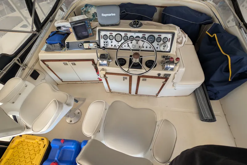 Slide: The Image of 1984 Chris-Craft 382 Commander boat cockpit with steering wheel and navigation equipment. - 11
