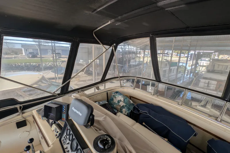 Slide: The Image of 1984 Chris-Craft 382 Commander helm with navigation equipment and marina view. - 17