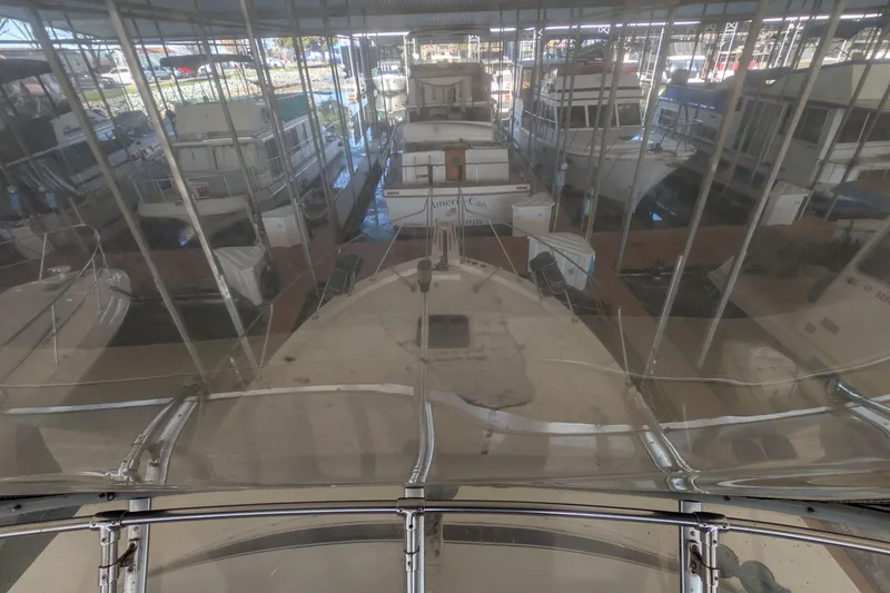 Slide: The Image of 1984 Chris-Craft 382 Commander docked in a marina with multiple boats. - 19