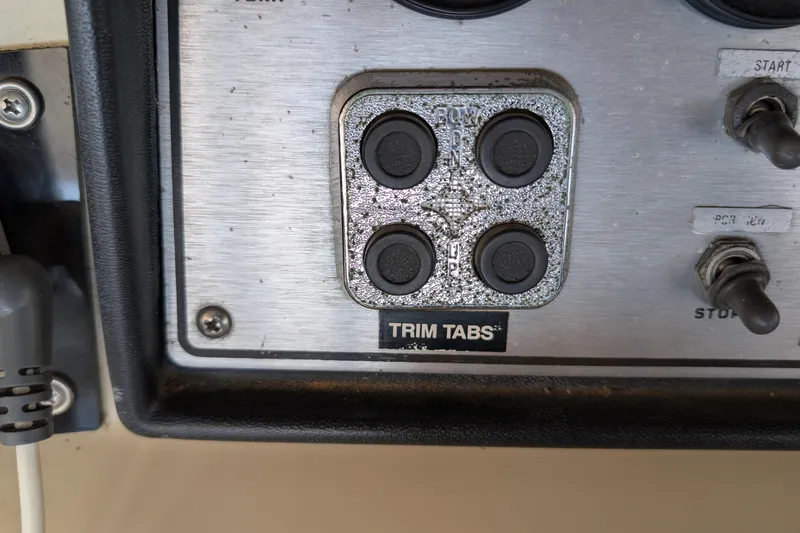 Slide: The Image of Control panel of 1984 Chris-Craft 382 Commander with trim tabs and switches. - 25