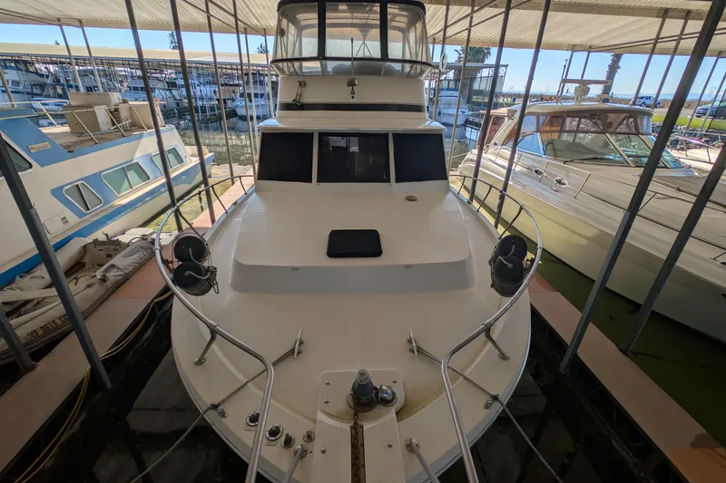 Slide: The Image of 1984 Chris-Craft 382 Commander docked in a marina, front view. - 3