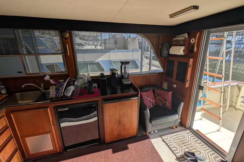 Slide: The Image of Interior of 1984 Chris-Craft 382 Commander yacht with kitchenette and seating area. - 35