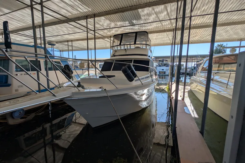 Slide: The Image of 1984 Chris-Craft 382 Commander yacht docked in a covered marina. - 4