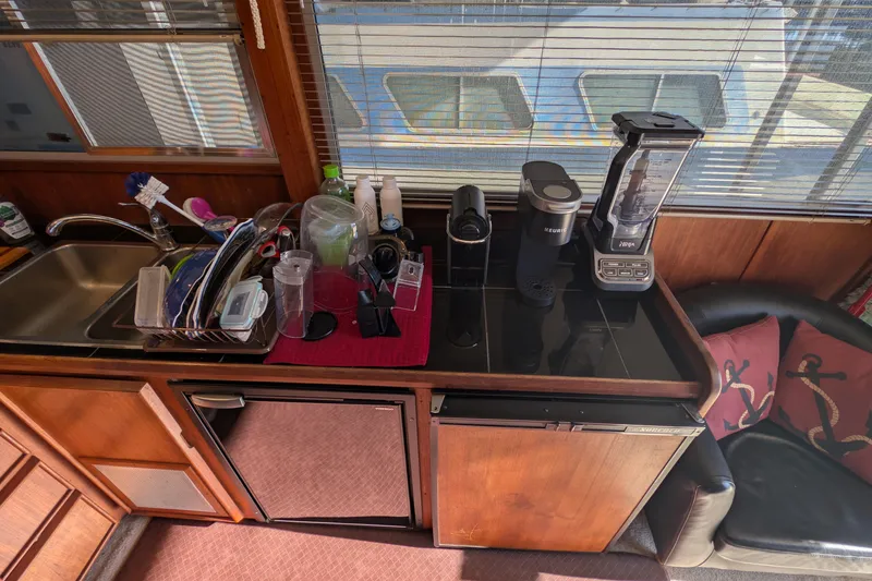 Slide: The Image of 1984 Chris-Craft 382 Commander kitchen with sink, appliances, and window view. - 45