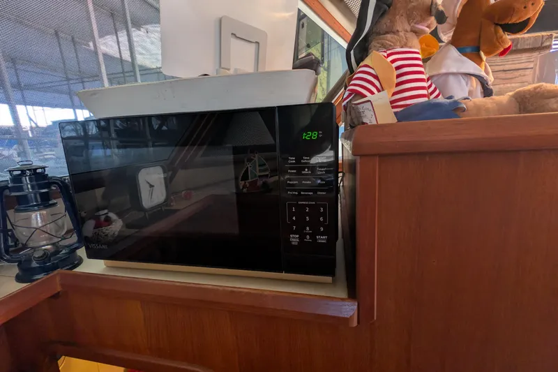 Slide: The Image of Microwave and decor inside 1984 Chris-Craft 382 Commander boat cabin. - 54