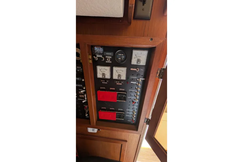 Slide: The Image of Electrical panel of 1984 Chris-Craft 382 Commander boat, featuring gauges and switches. - 56