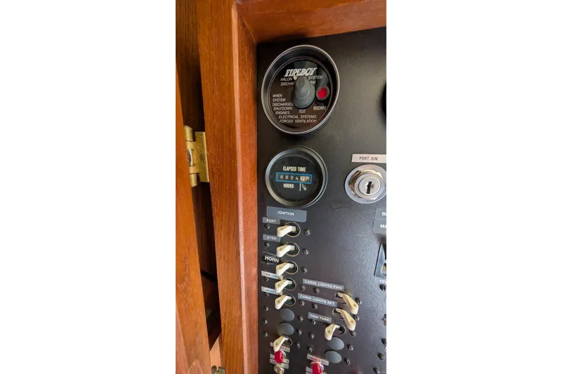 Slide: The Image of Control panel of 1984 Chris-Craft 382 Commander with switches and gauges. - 58