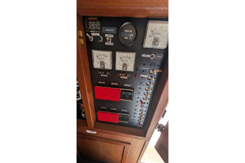 Slide: The Image of Electrical control panel of a 1984 Chris-Craft 382 Commander boat, featuring gauges and switches. - 61