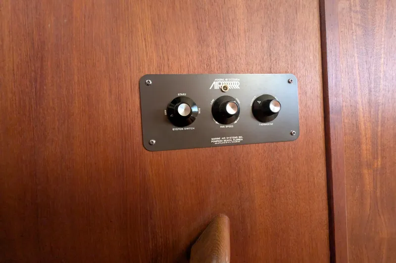 Slide: The Image of Control panel on 1984 Chris-Craft 382 Commander boat, featuring system switch and thermostat. - 65